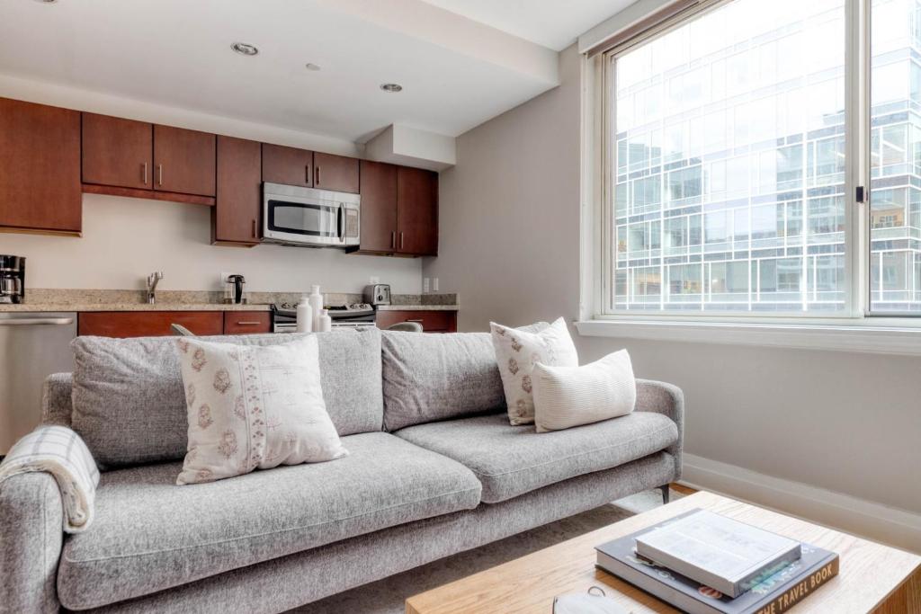 a living room with a couch and a kitchen at Foggy Bottom 1br w wd pool gym nr Georgetown WDC-652 in Washington