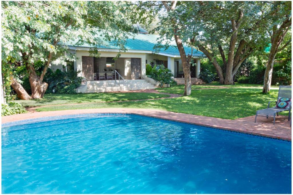 a swimming pool in front of a house at 701 Victoria Falls in Victoria Falls