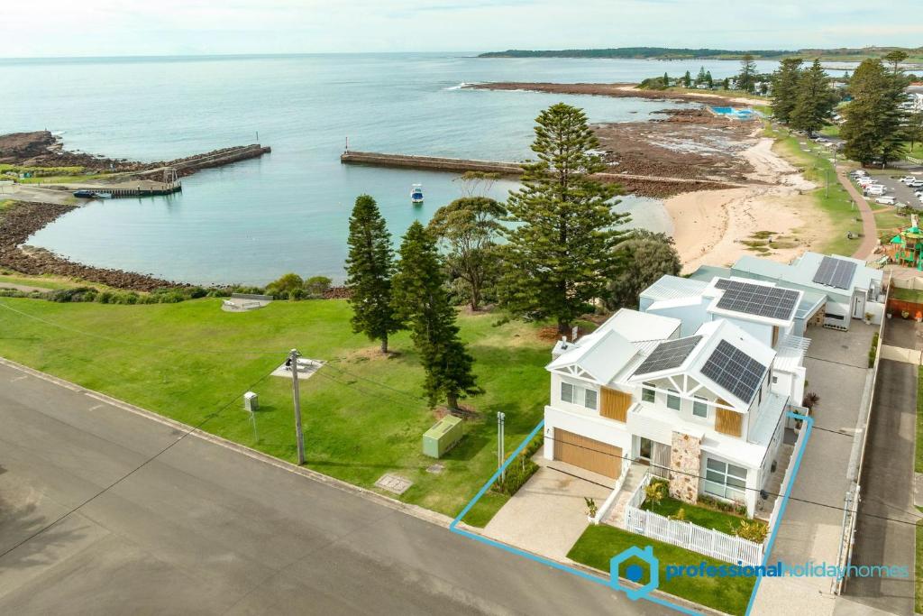 an aerial view of a house and the ocean at LegaSea Lodge - Pet Friendly Beachfront with Plunge Pool in Shellharbour