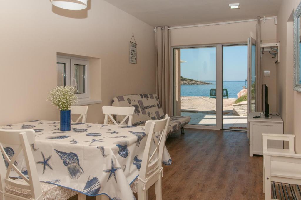 a dining room with a table and a view of the ocean at Villa Sv. Martin in Mali Lošinj