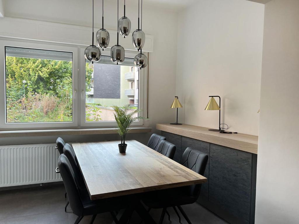 a dining room with a wooden table and chairs at Apartment Wesseling in Wesseling