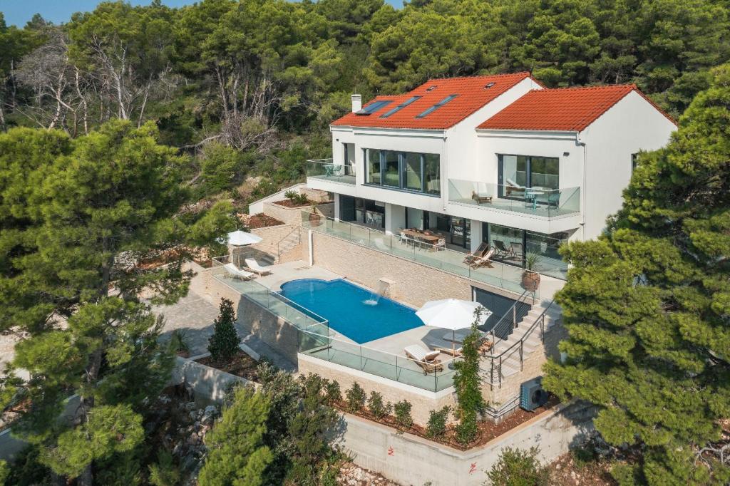 an aerial view of a house with a swimming pool at Stylish Lumbarda Villa Sleeps 10 with Private Pool in Lumbarda
