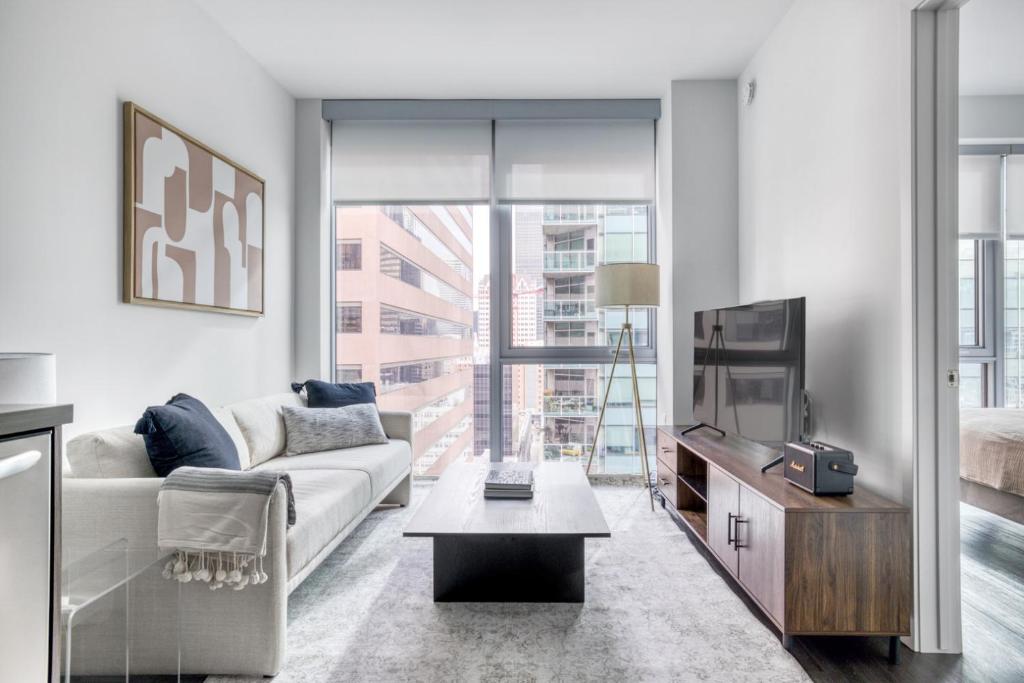 a living room with a couch and a tv at Downtown 1BR w Pool Gym nr Staples Center LAX-624 in Los Angeles