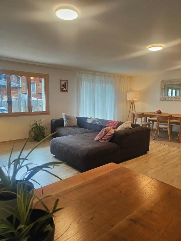 a living room with a couch and a table at Casa LeYu mitten in Ruschein in Ruschein