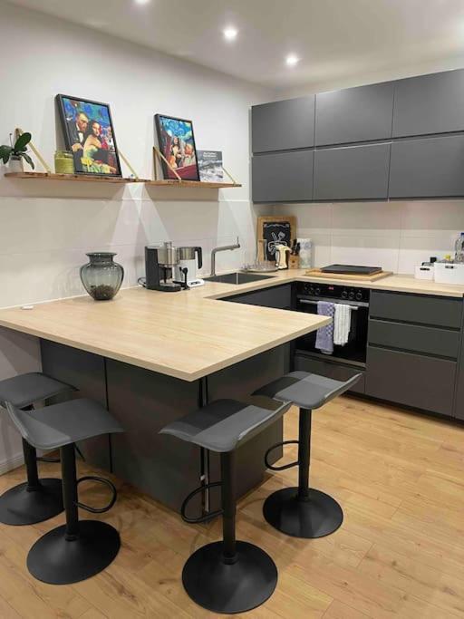 a kitchen with a counter and two stools in it at Messe- Augsburg- Legoland Günzburg - 6 Personen in Zusmarshausen