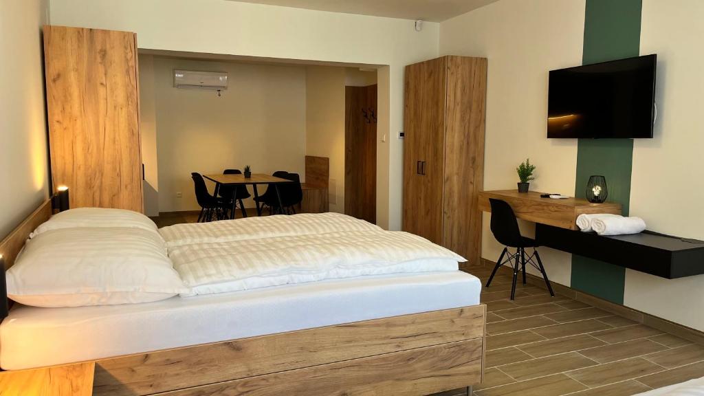 Postel nebo postele na pokoji v ubytování Rezidex Apartmanház
