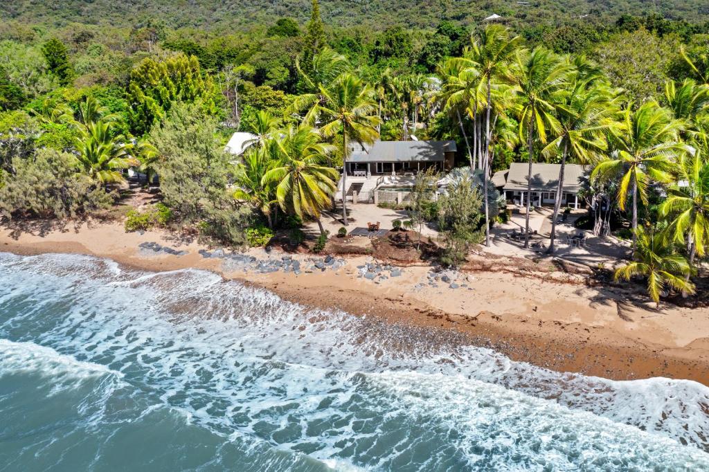 an aerial view of a beach with palm trees at Oceans Edge Beach House At Oak Beach in Oak Beach