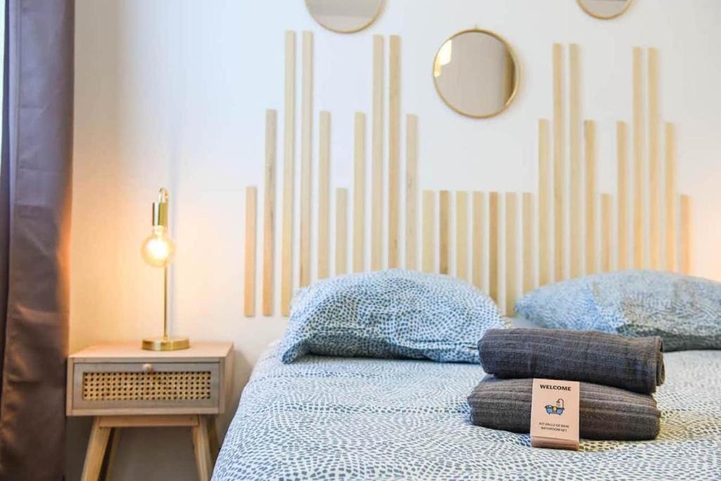 a bedroom with a bed with pillows and a mirror at Appartement Vieux-Port de Marseille - Opéra - 3 étoiles in Marseille