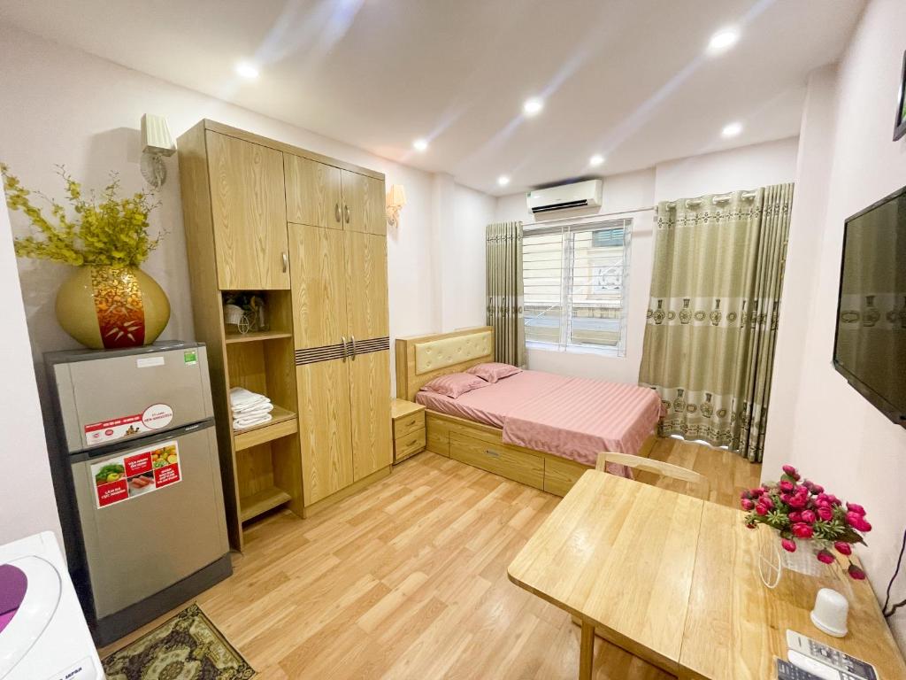 a small room with a bed and a table at Joy Homestay in Hanoi