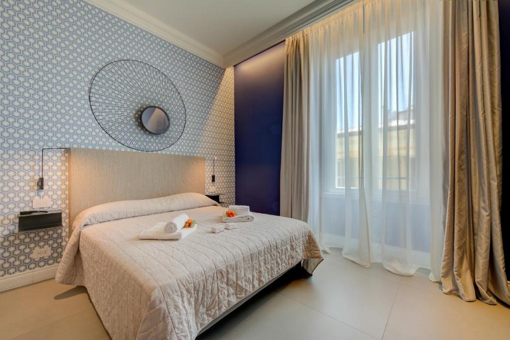 Postel nebo postele na pokoji v ubytování Seven Suites Apartments - Via Matteotti 178