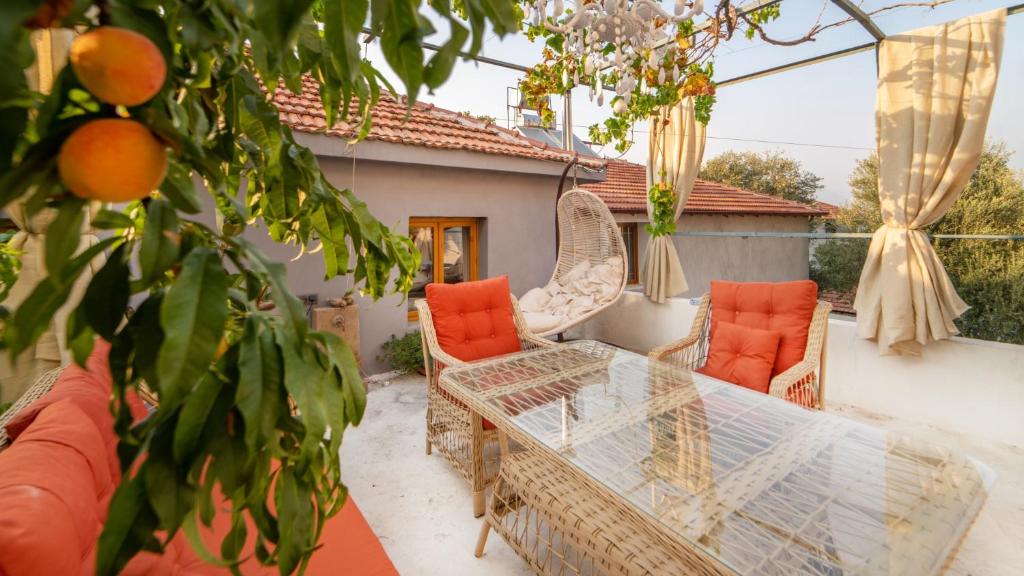 Cozy Oasis with Lovely Backyard in Fethiye في فتحية: فناء مع طاولة وكراسي زجاجية