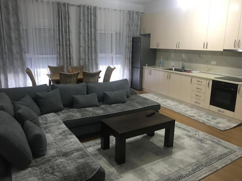 a living room with a couch and a table at Alban Apartment in Tirana
