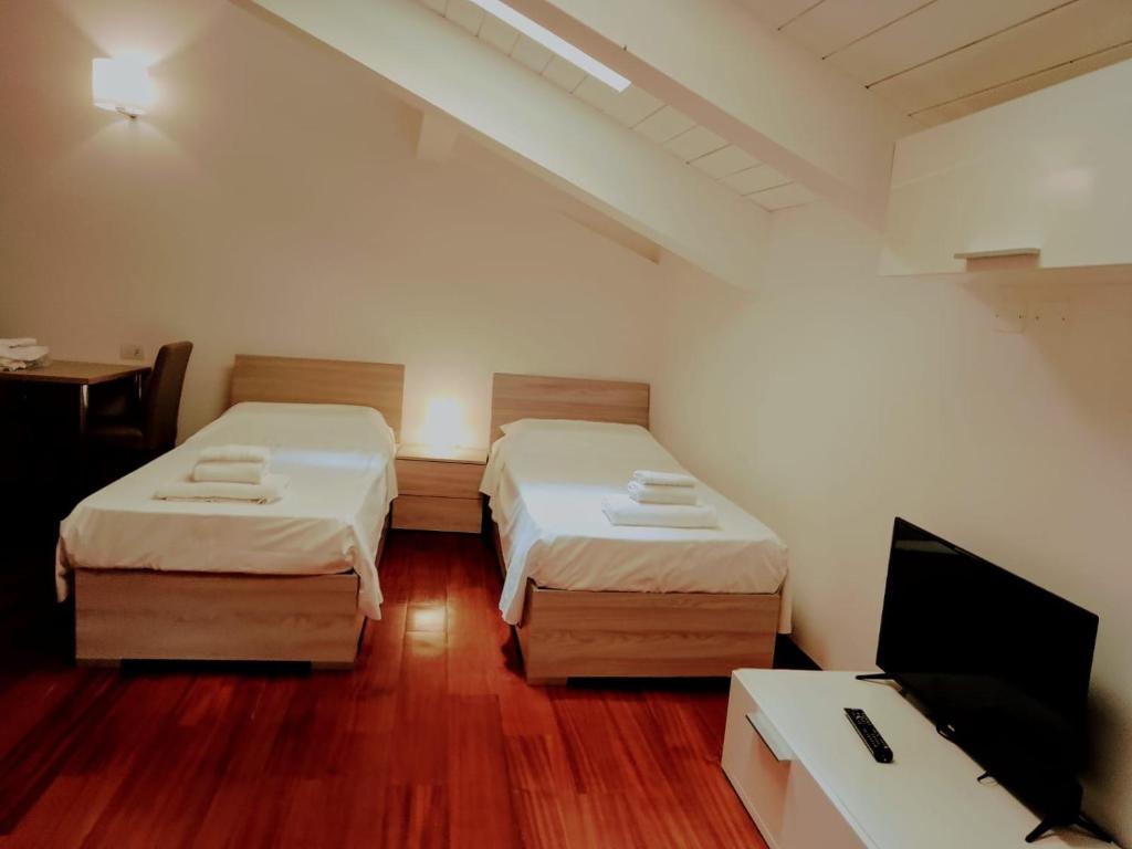 A bed or beds in a room at Ego' Residence Ferrara