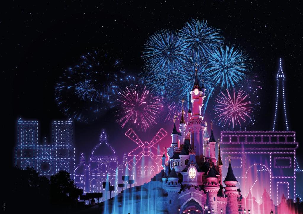 a nighttime picture of a disney castle with fireworks at House with garden Disneyland Paris in Magny-le-Hongre