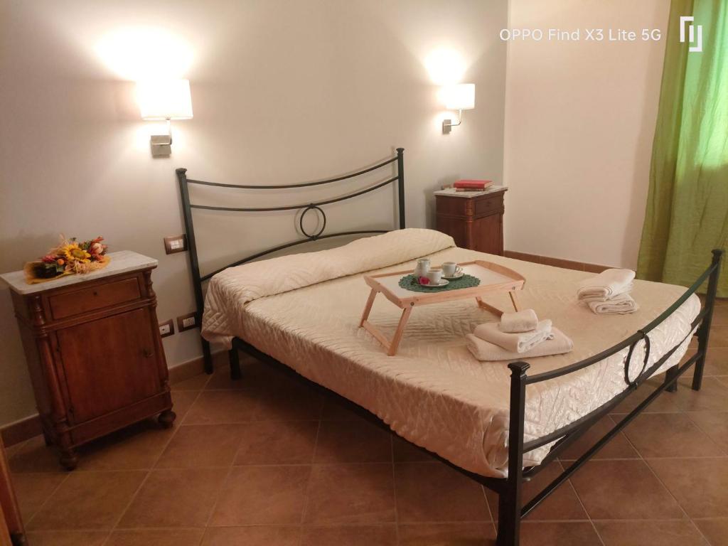 a small bedroom with a bed and a night stand at Tenuta Villa Torriti in Civitella dʼAgliano