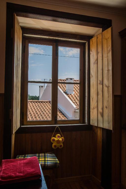 a window in a room with a view of a roof at Sintra Small Hostel in Sintra