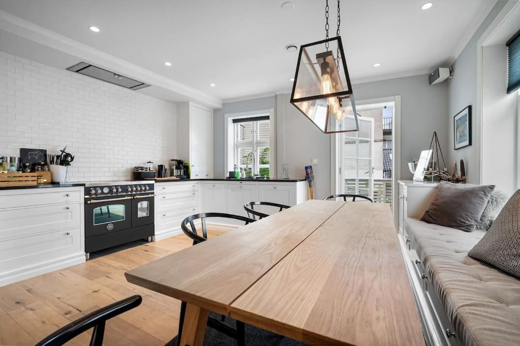 a kitchen and dining room with a wooden table at Beautiful townhouse super Central in Bergen - 4 bedrooms 8 guests in Bergen