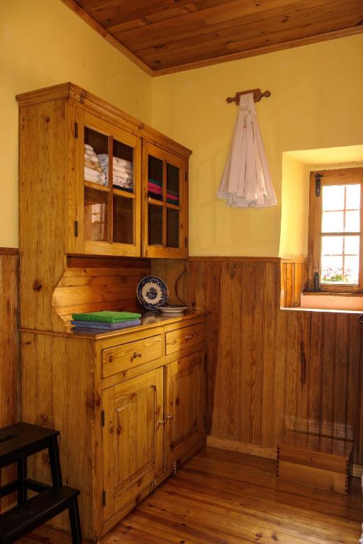 a kitchen with a wooden cabinet and a window at Sintra Small Hostel in Sintra