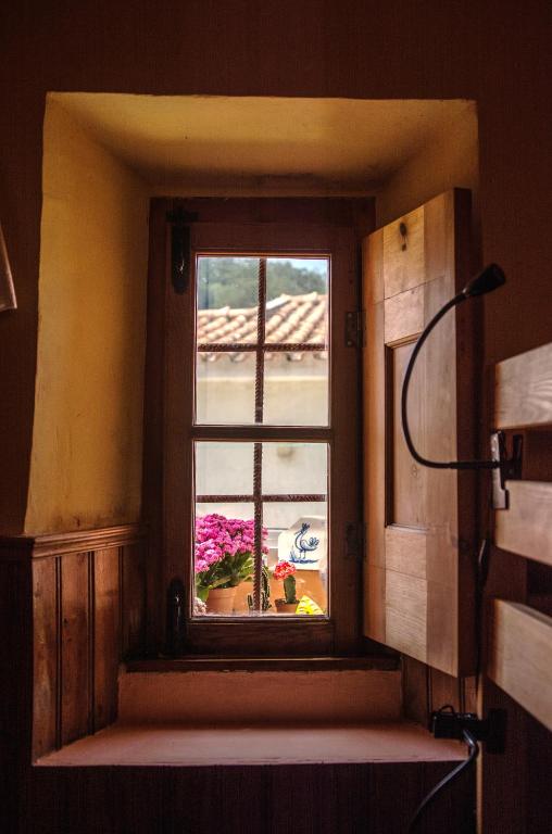 a window in a kitchen with a view of a yard at Sintra Small Hostel in Sintra