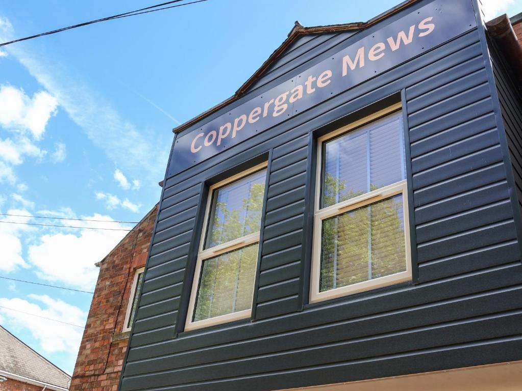 a black building with two windows on the side of it at Apartment 4 in Grimsby