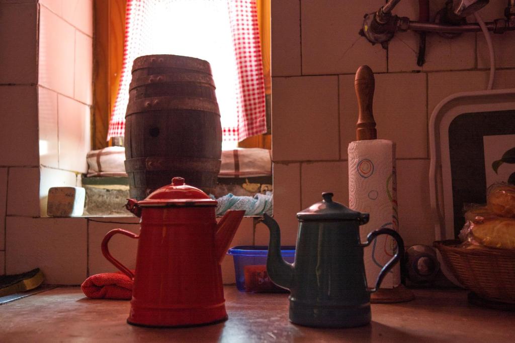 a kitchen counter with two kettles on a table at Sintra Small Hostel in Sintra