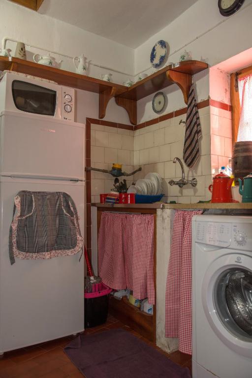 a kitchen with a washing machine in a kitchen at Sintra Small Hostel in Sintra