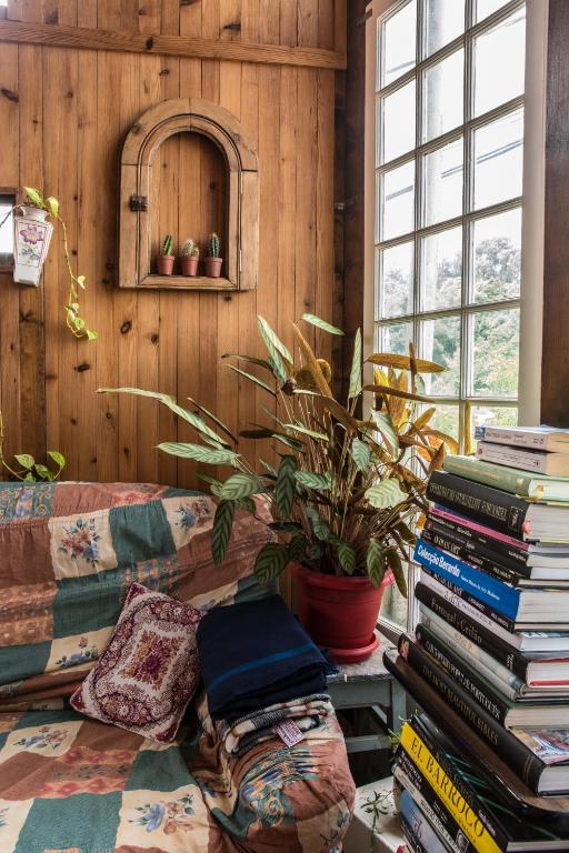 a room with a couch and a stack of books at Sintra Small Hostel in Sintra