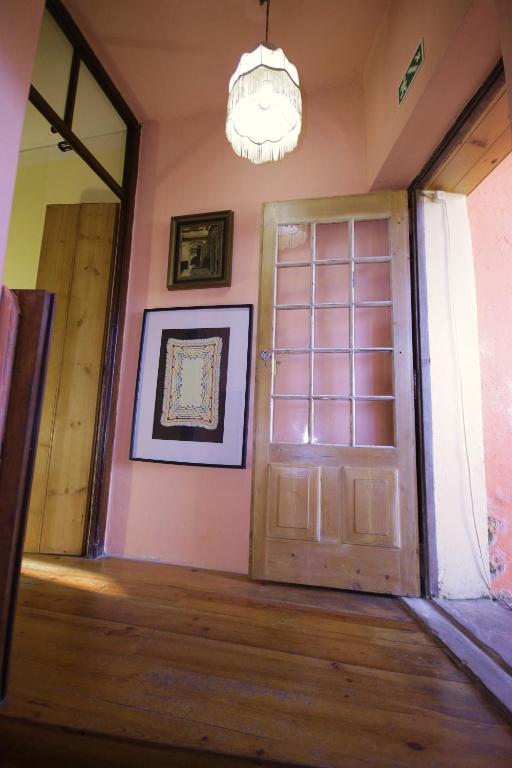 an empty room with a door and a chandelier at Sintra Small Hostel in Sintra