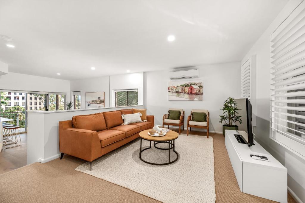 a living room with a couch and a table at Townhouse on The Hill in Newcastle