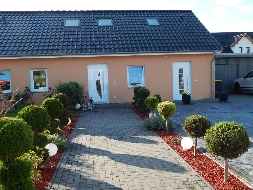 a house with a brick driveway in front of it at Grit´s Ferienwohnung in Ostseebad Karlshagen