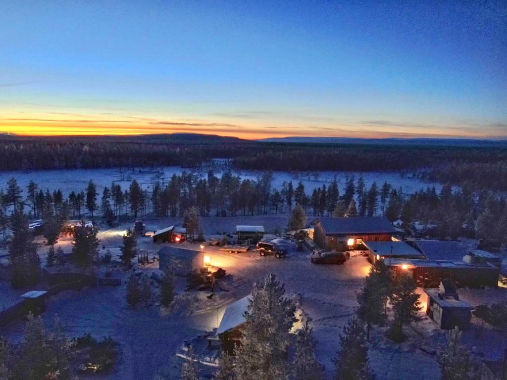 an aerial view of a lodge in the snow at sunset at Offroadcamp in Sörsjön