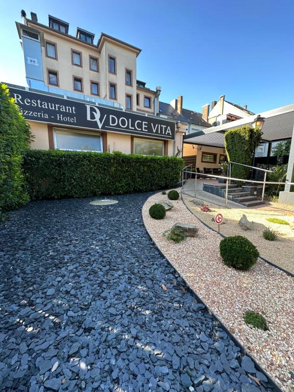 a building with a stone walkway in front of a building at Dolce Vita in Mondorf-les-Bains