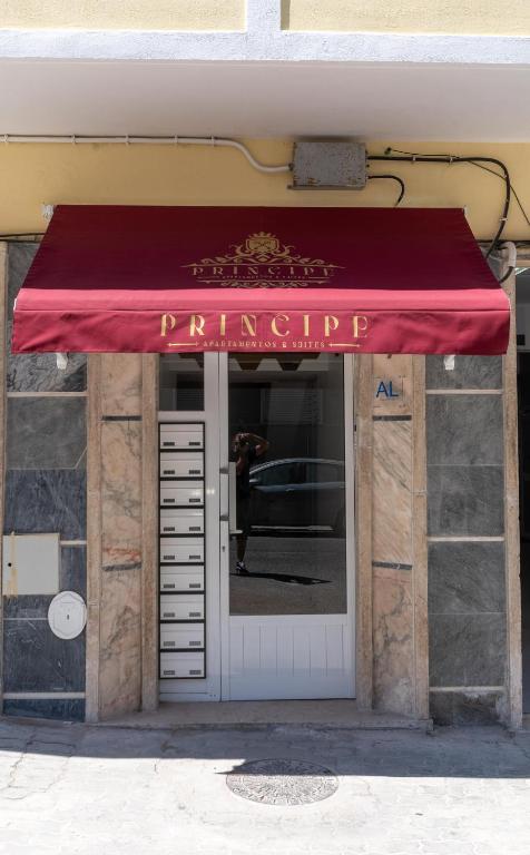 a red awning over the door of a building at Príncipe Apartamentos e Suites in Lisbon