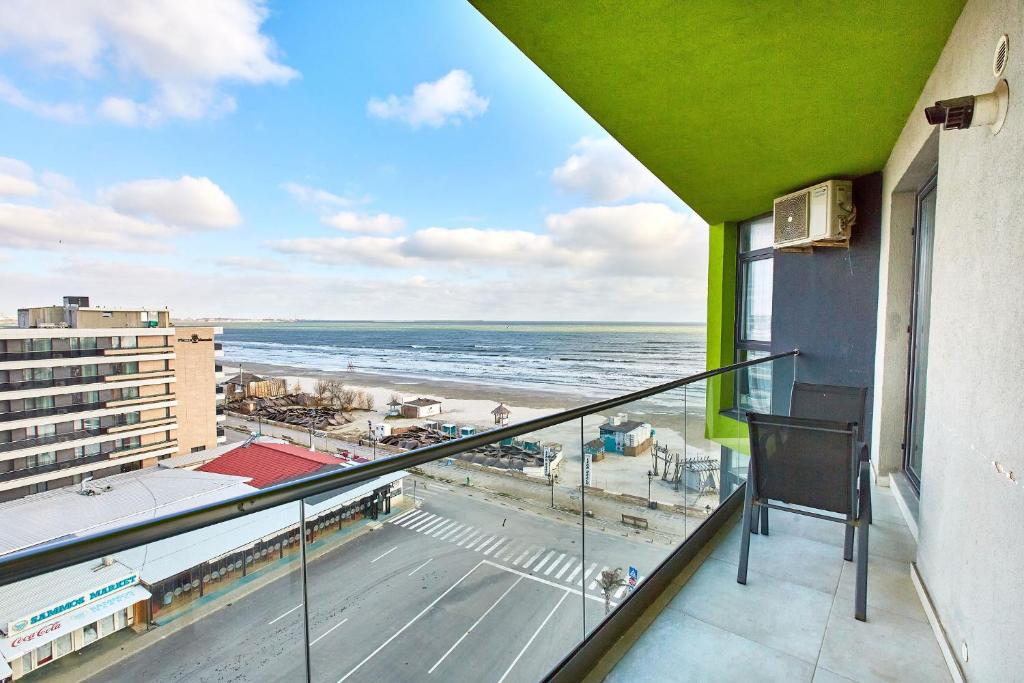 a balcony with a view of a beach and the ocean at Sea View by Alz in Mamaia Sat/Năvodari