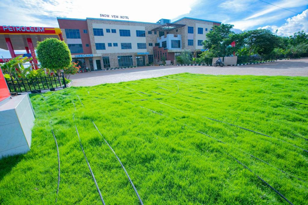 a large field of green grass in front of a building at Snow View Annex in Himo