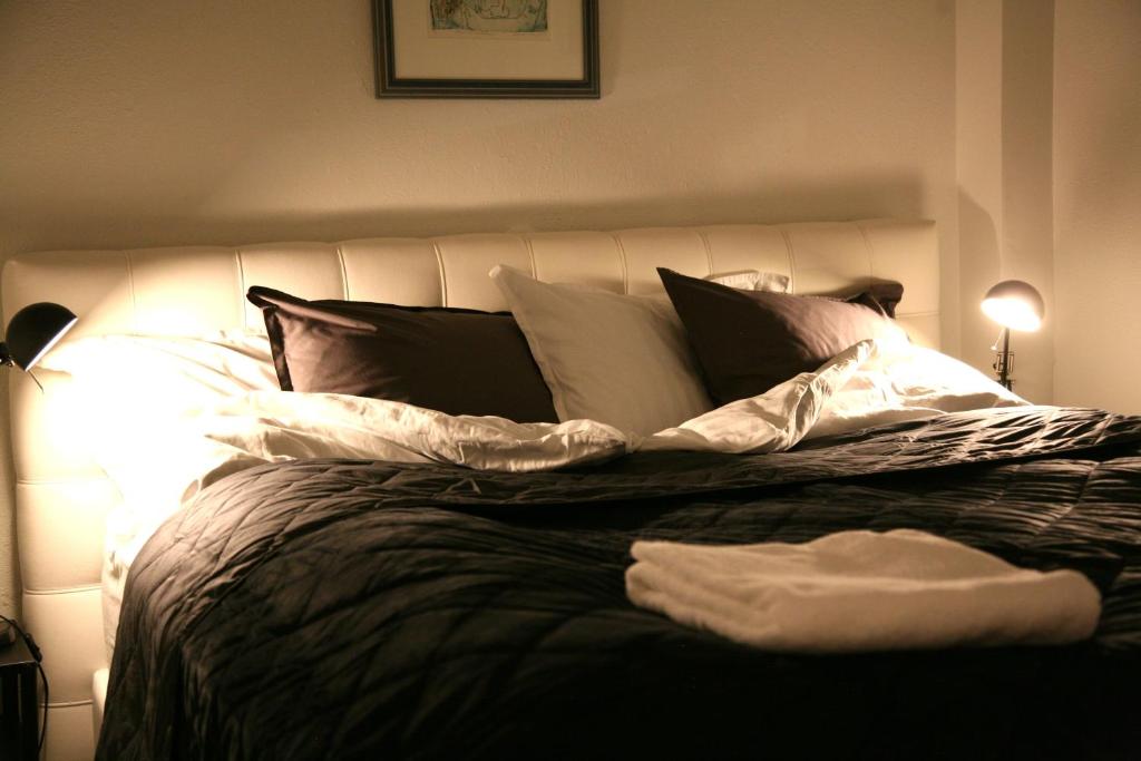 a bedroom with a large bed with pillows at Spacious & refurbished 1 bedroom apartment in suburban Reykjavik in Garðabær