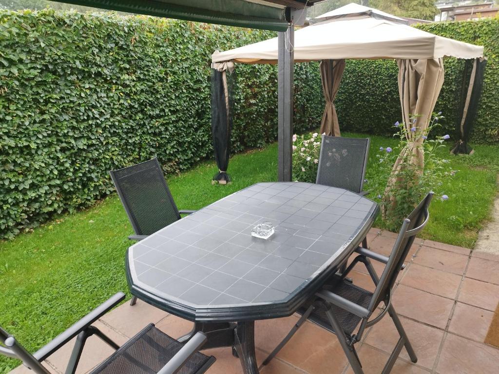 a table and chairs under an umbrella on a patio at durbuy intimité vintage in Durbuy