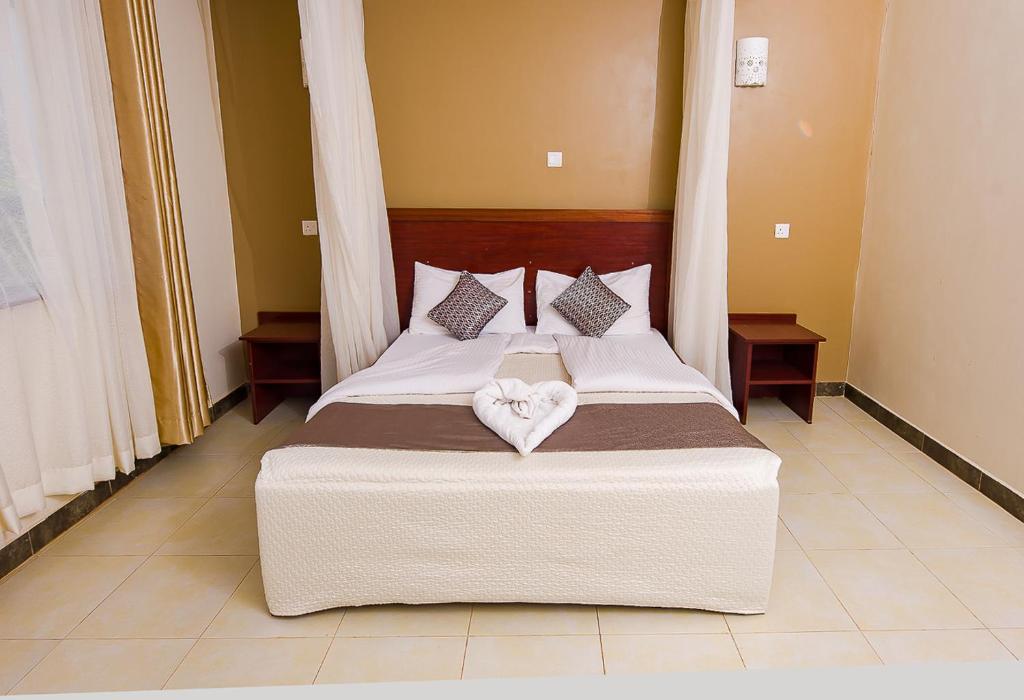 a bedroom with a bed with two hearts on it at Acacia Resort Wote-Makueni by Nest & Nomad in Wote