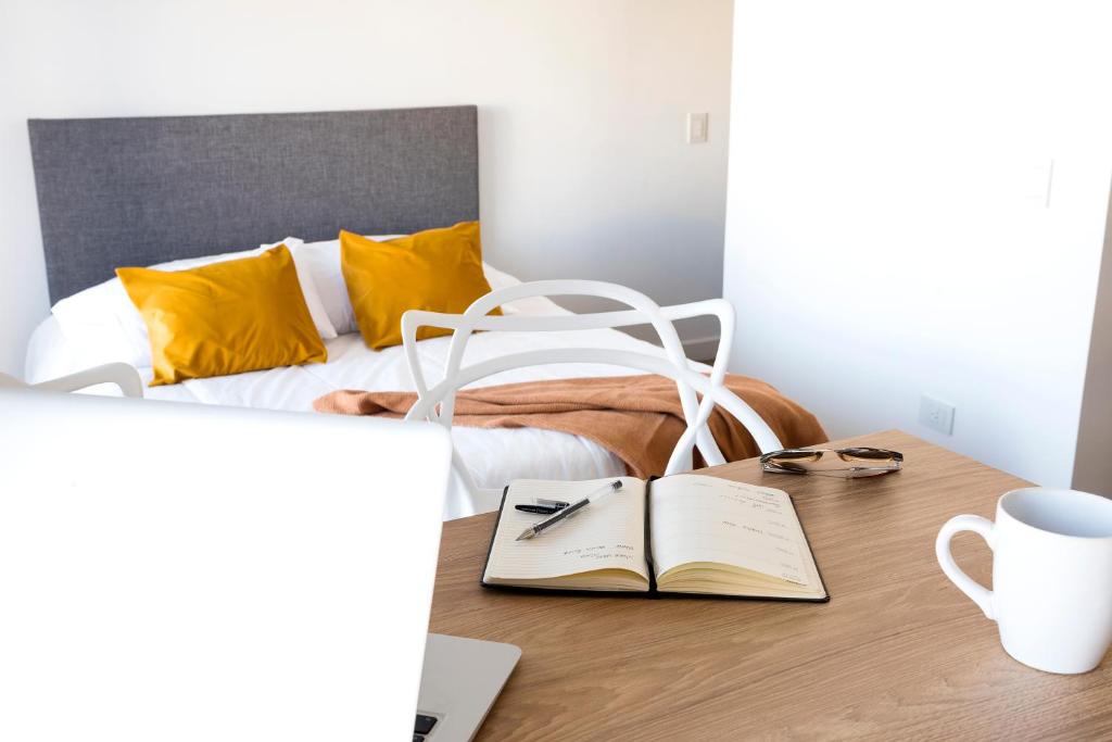 a bedroom with a bed and a desk with a book at Studio con amenities en Palermo - Recoleta in Buenos Aires
