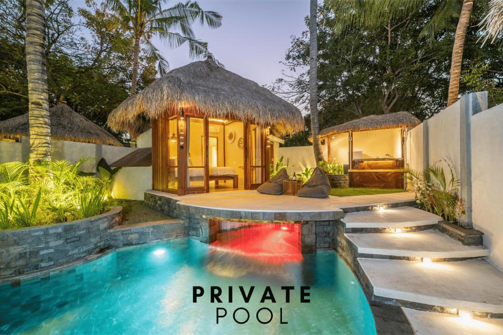 a pool in front of a resort with a pavilion at The Cove Gili Air in Gili Air