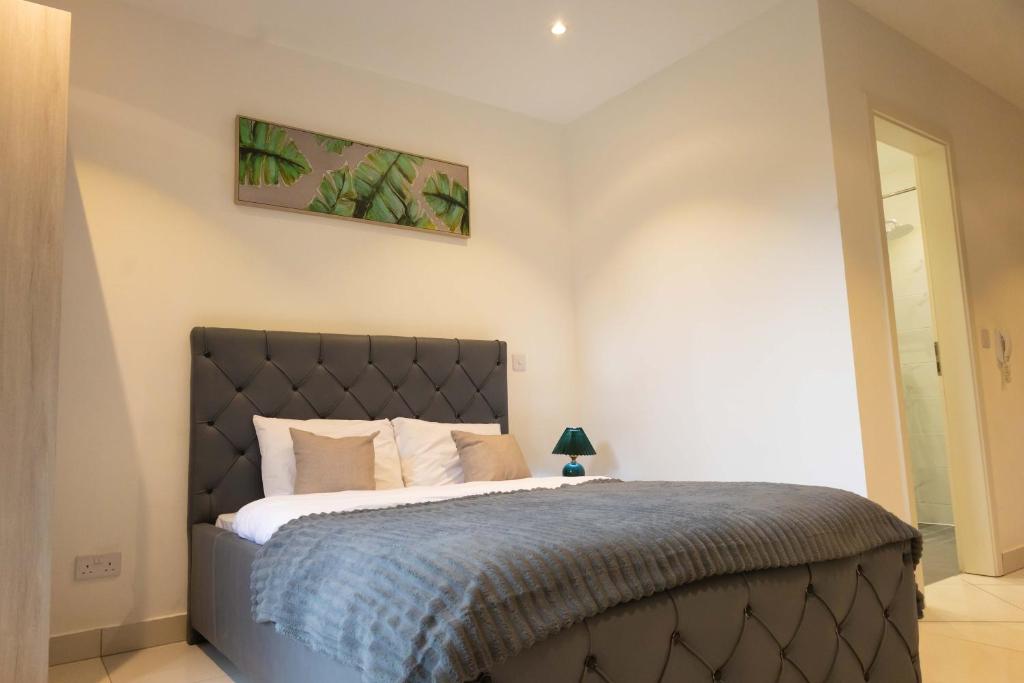 a bedroom with a large bed in a room at The Eden Suite in Accra