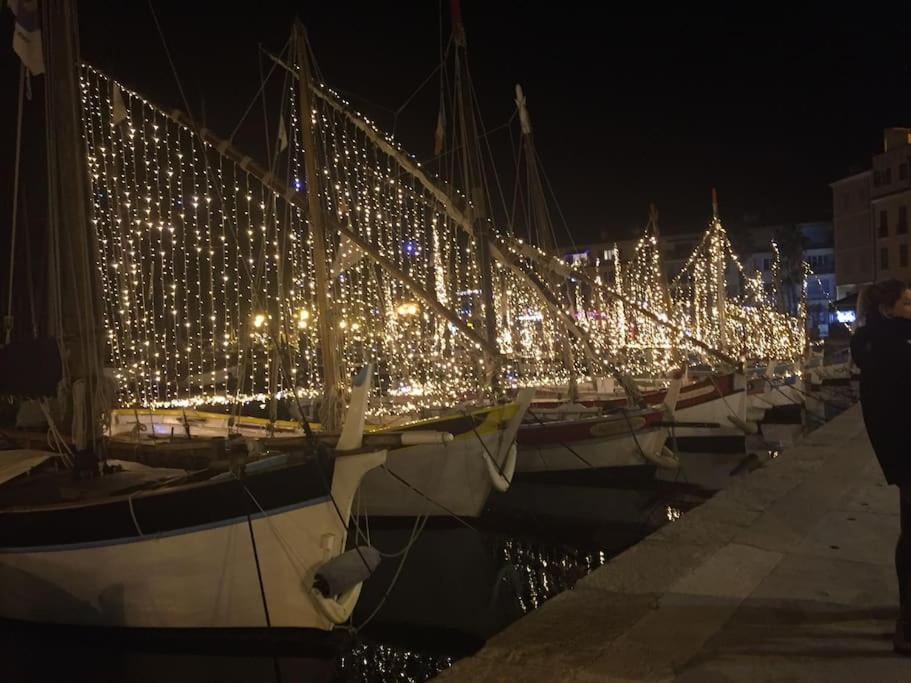 a row of boats with christmas lights on them at emplacement idéal, vue mer, parking offert in Sanary-sur-Mer