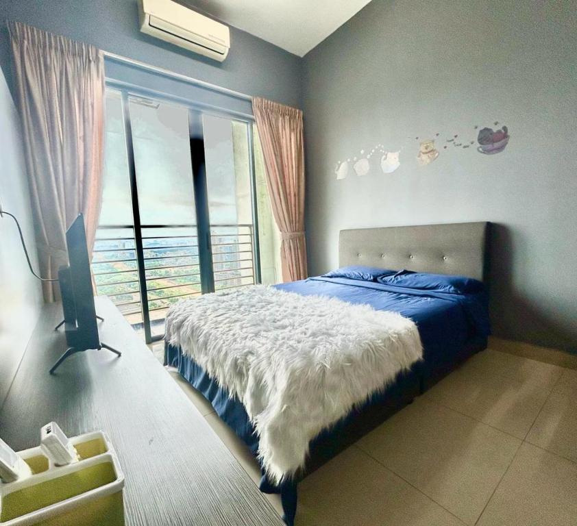 a bedroom with a bed and a television and a window at Modern Dpulze Soho fit 4pax,Netflix provided in Cyberjaya
