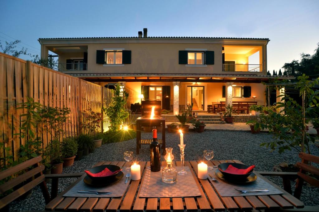 a table in front of a house with candles at Villa Gaia in Dassia