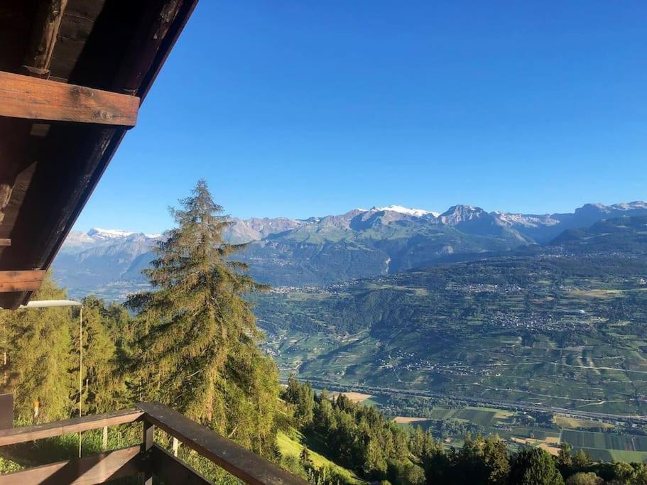a view of a mountain valley with a pine tree at Chalet avec vue imprenable et au calme in Chalais