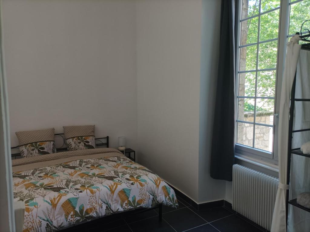 a bedroom with a bed and a window at O'Couvent - Appartement 71 m2 - 1 chambre - A222 in Salins-les-Bains