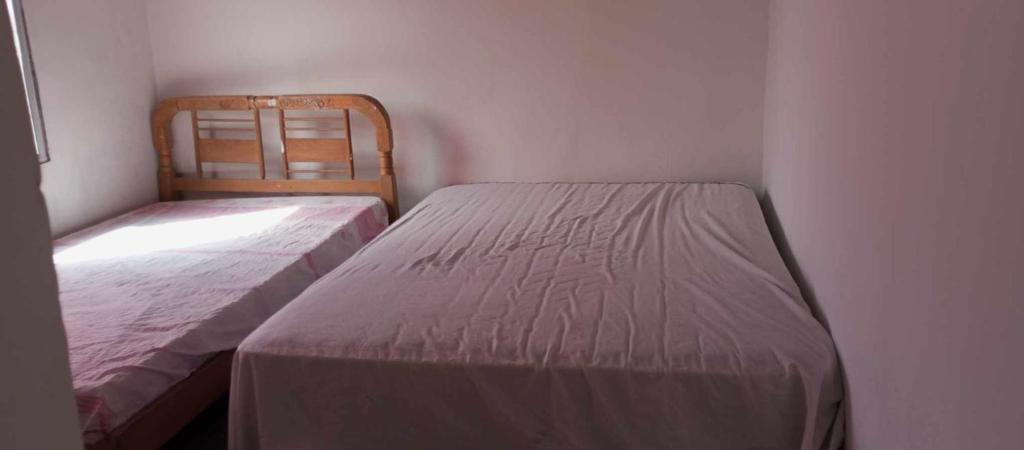 a bedroom with two beds and a chair in it at Casa Ayangue in Santa Elena