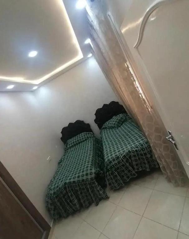 two beds sitting on the floor in a room at Dayar arrid in Nador