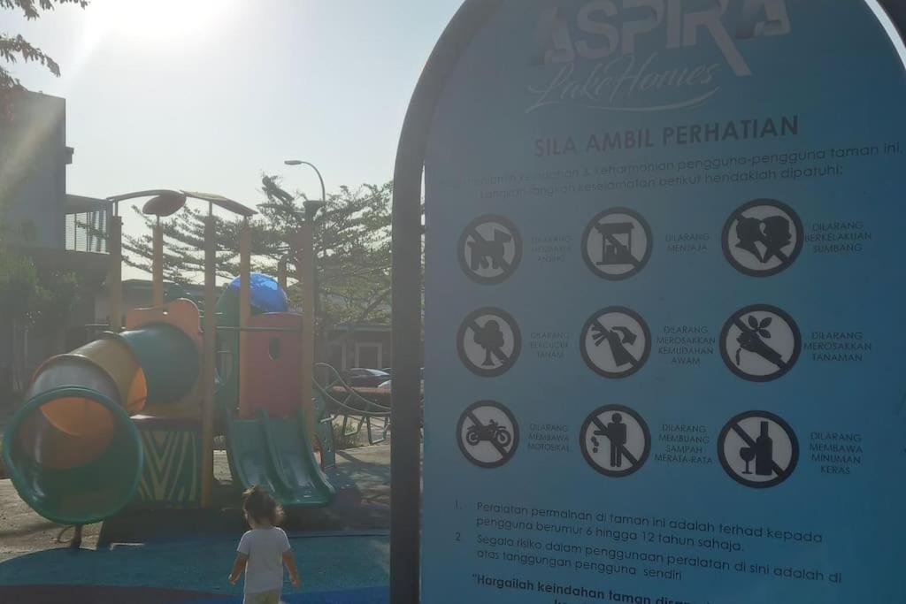 a sign in front of a playground with a slide at LakeHomes 10 min to LEGOLAND in Gelang Patah