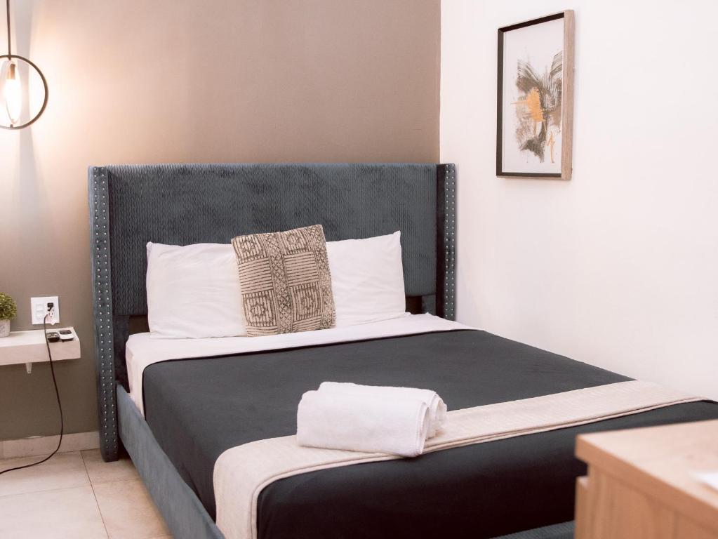 Postel nebo postele na pokoji v ubytování La Buena Vida Inn